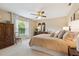 Cozy bedroom featuring a queen bed with an abundance of pillows and a ceiling fan at 906 Crestview Dr, Auburndale, FL 33823
