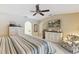 Comfortable bedroom features a king bed, ceiling fan, and neutral decor at 906 Crestview Dr, Auburndale, FL 33823