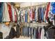 Walk-in closet with hanging clothes on racks from top to bottom at 906 Crestview Dr, Auburndale, FL 33823