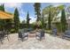 Cozy outdoor fire pit area with ample seating and privacy landscaping at 906 Crestview Dr, Auburndale, FL 33823