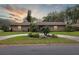 Charming single-story brick home with a circular driveway and professionally landscaped front yard at 906 Crestview Dr, Auburndale, FL 33823