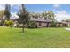 Well-manicured front lawn and landscaping of this brick home give it inviting curb appeal at 906 Crestview Dr, Auburndale, FL 33823