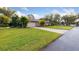 Well maintained lawn, circular driveway, and attached two-car garage enhance this home's curb appeal at 906 Crestview Dr, Auburndale, FL 33823