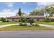 Manicured front lawn and landscaping of this brick home give it inviting curb appeal at 906 Crestview Dr, Auburndale, FL 33823