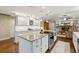 Bright kitchen with granite countertops, stainless appliances, and a view into the living room at 906 Crestview Dr, Auburndale, FL 33823