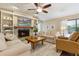 Cozy living room with a fireplace, built-in shelves, and neutral decor at 906 Crestview Dr, Auburndale, FL 33823