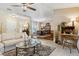 Open-concept living room with neutral tones, a ceiling fan, and seamless flow to the dining area at 906 Crestview Dr, Auburndale, FL 33823