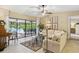 Cozy living room featuring sliding glass doors that open to the pool area and outdoor living space at 906 Crestview Dr, Auburndale, FL 33823