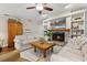 Inviting living room features built-in shelving and a stone fireplace at 906 Crestview Dr, Auburndale, FL 33823