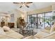 Open living area offering seamless access to the outdoor patio and pool with comfortable furniture at 906 Crestview Dr, Auburndale, FL 33823