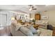 Open-concept living room with hardwood floors and access to a bright kitchen area at 906 Crestview Dr, Auburndale, FL 33823