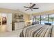 Bright bedroom offering pool views, a ceiling fan, and an ensuite bathroom at 906 Crestview Dr, Auburndale, FL 33823