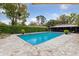 Backyard pool with screened enclosure and manicured landscaping at 906 Crestview Dr, Auburndale, FL 33823