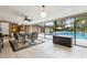 Inviting sun room features an enclosed patio with seating near a shimmering pool at 906 Crestview Dr, Auburndale, FL 33823