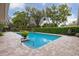 Backyard pool with lush landscaping and brick paver patio at 906 Crestview Dr, Auburndale, FL 33823