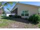 Backyard featuring neutral siding, screened in porch, manicured landscaping and large window at 915 Ashmeade Ct, Port Orange, FL 32127