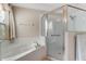 Bathroom with garden tub, tiled walls, glass enclosed shower, and towel rack at 915 Ashmeade Ct, Port Orange, FL 32127