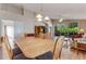 Dining area with a ceiling fan and hardwood floors is conveniently located near the living room at 915 Ashmeade Ct, Port Orange, FL 32127
