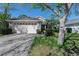 Charming home featuring a two-car garage, manicured lawn, and lush landscaping at 915 Ashmeade Ct, Port Orange, FL 32127