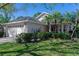 Charming single-story home featuring mature landscaping and an attached two-car garage at 915 Ashmeade Ct, Port Orange, FL 32127