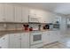 Well-maintained kitchen featuring white cabinetry, tiled countertops, and modern appliances at 915 Ashmeade Ct, Port Orange, FL 32127