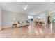 Open-concept living space with hardwood flooring, a ceiling fan, and great natural light at 915 Ashmeade Ct, Port Orange, FL 32127