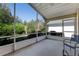 Relaxing screened porch with lush landscaping, overhead fan, and concrete floors, perfect for enjoying the outdoors bug-free at 915 Ashmeade Ct, Port Orange, FL 32127