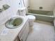 Traditional bathroom with green fixtures, tile surround, and ample space at 1040 Ne 25Th St, Ocala, FL 34470