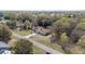 Aerial view of home and detached two-car garage surrounded by mature trees and a long driveway at 5238 Ne 1St Ave, Ocala, FL 34479