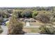 Aerial view of a home with a detached two-car garage, long driveway and mature trees at 5238 Ne 1St Ave, Ocala, FL 34479