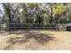 Sprawling backyard with lush greenery and a wooden fence, offering privacy and space at 5238 Ne 1St Ave, Ocala, FL 34479