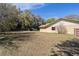 Extensive backyard view featuring shed, trees and fenced area for outdoor activities at 5238 Ne 1St Ave, Ocala, FL 34479