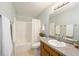 Bright bathroom featuring a shower-tub combo and a vanity with a sink and mirror at 5238 Ne 1St Ave, Ocala, FL 34479