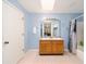 Bathroom with a double sink vanity, tub with shower, and blue wall paint at 5238 Ne 1St Ave, Ocala, FL 34479