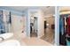 Bathroom featuring a shower-tub combo, walk-in closet, and wood-look floors at 5238 Ne 1St Ave, Ocala, FL 34479