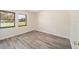 Bright bedroom showcasing hardwood floors, and two windows at 5238 Ne 1St Ave, Ocala, FL 34479