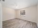 Sunlit bedroom with wood-look floors, a ceiling fan, and a lovely view at 5238 Ne 1St Ave, Ocala, FL 34479