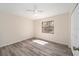 Bright bedroom featuring hardwood floors, a window with natural light, and crisp white walls at 5238 Ne 1St Ave, Ocala, FL 34479