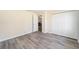 Bright bedroom featuring hardwood floors, a closet, and crisp white walls at 5238 Ne 1St Ave, Ocala, FL 34479