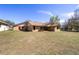 Exterior of home with spacious green lawn and neutral color at 5238 Ne 1St Ave, Ocala, FL 34479