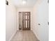 Hallway featuring tiled floors, access to the backyard, and a white door at 5238 Ne 1St Ave, Ocala, FL 34479