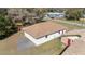 Aerial view of a detached two-car garage with a red access door next to the main house at 5238 Ne 1St Ave, Ocala, FL 34479