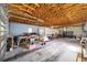 Bright, spacious garage with exposed ceiling beams and parked vehicles and stored items at 5238 Ne 1St Ave, Ocala, FL 34479