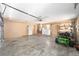 Spacious garage interior with washer, dryer, lawn mower, storage and concrete floor at 5238 Ne 1St Ave, Ocala, FL 34479