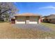 A two-car detached garage with stone accents sits on a gravel bed under a bright blue sky at 5238 Ne 1St Ave, Ocala, FL 34479