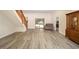 Open living room with sleek flooring, staircase, sliding glass doors, and natural light at 5238 Ne 1St Ave, Ocala, FL 34479