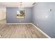 Empty living room with updated gray floors, fresh paint, and modern chandelier at 5238 Ne 1St Ave, Ocala, FL 34479