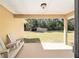 Covered outdoor patio with white seating overlooking backyard and shed at 5238 Ne 1St Ave, Ocala, FL 34479