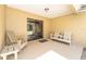 Covered patio with sliding glass door, seating, and concrete flooring at 5238 Ne 1St Ave, Ocala, FL 34479