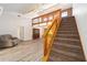 Home staircase leading to loft with wooden railing, lighting fixtures and neutral tones at 5238 Ne 1St Ave, Ocala, FL 34479